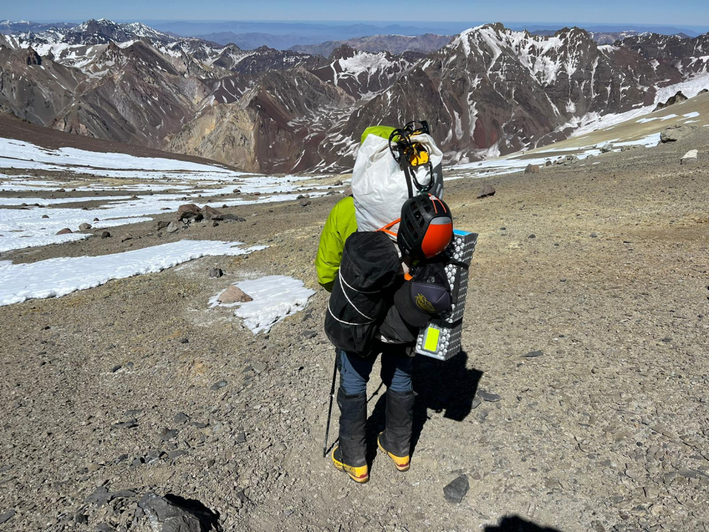 Climber, Matthew Russell descending with a heavy pack down the mountain.